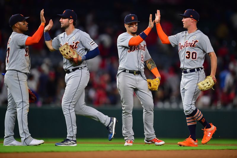 Sep 15, 2023; Anaheim, California, USA; Detroit Tigers second baseman Andy Ibanez (77) left fielder Matt Vierling (8) shortstop Javier Baez (21) and right fielder Kerry Carpenter (30) celebrate the victory against the Los Angeles Angels at Angel Stadium. Mandatory Credit: Gary A. Vasquez-USA TODAY Sports