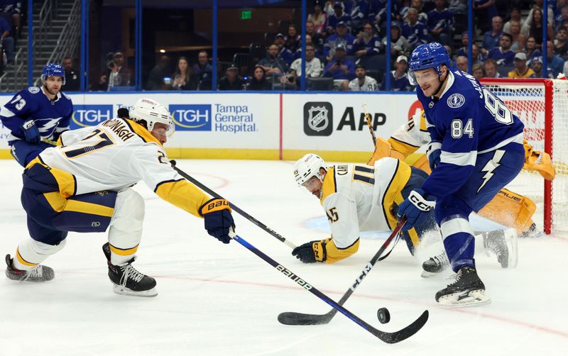 Oct 10, 2023; Tampa, Florida, USA; Tampa Bay Lightning left wing Tanner Jeannot (84) skates with the puck as Nashville Predators defenseman Ryan McDonagh (27) defends during the first period at Amalie Arena. Mandatory Credit: Kim Klement Neitzel-USA TODAY Sports