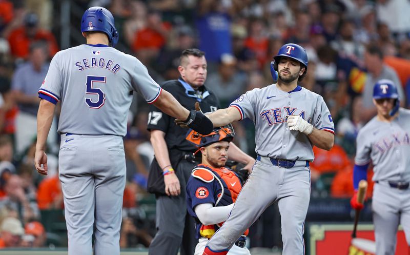 Jul 14, 2024; Houston, Texas, USA; Texas Rangers third baseman Josh Smith (8) celebrates with shortstop Corey Seager (5) after hitting a two-run home run during the eighth inning against the Houston Astros at Minute Maid Park. Mandatory Credit: Troy Taormina-USA TODAY Sports