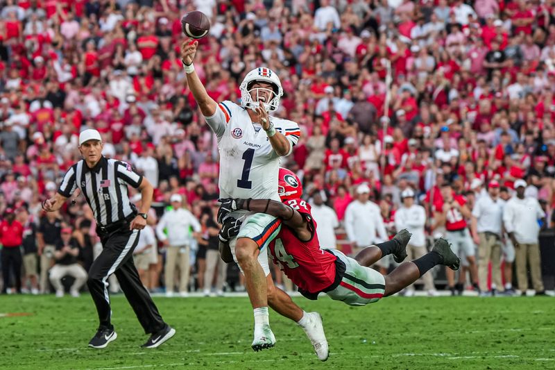 Oct 5, 2024; Athens, Georgia, USA; Auburn Tigers quarterback Payton Thorne (1) runs and throws chased by Georgia Bulldogs defensive back Malaki Starks (24) during the second half at Sanford Stadium. Mandatory Credit: Dale Zanine-Imagn Images