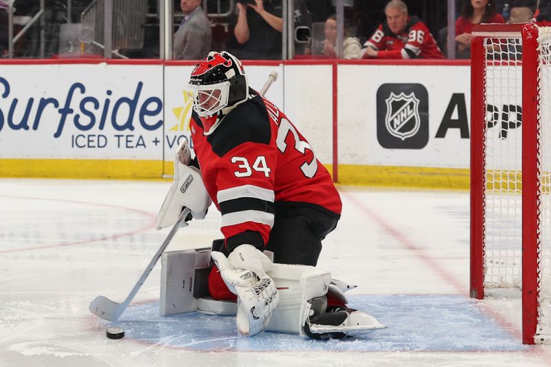 Jan 4, 2026; Newark, New Jersey, USA; New Jersey Devils goaltender Jake Allen (34) makes a save against the Carolina Hurricanes during the third period at Prudential Center. Mandatory Credit: Ed Mulholland-Imagn Images