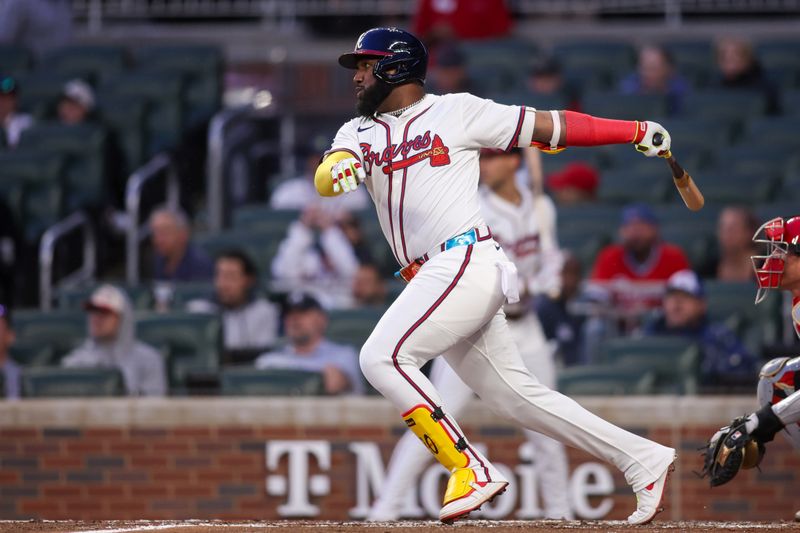 Apr 10, 2025; Atlanta, Georgia, USA; Atlanta Braves designated hitter Marcell Ozuna (20) hits a single against the Philadelphia Phillies in the third inning at Truist Park. Mandatory Credit: Brett Davis-Imagn Images