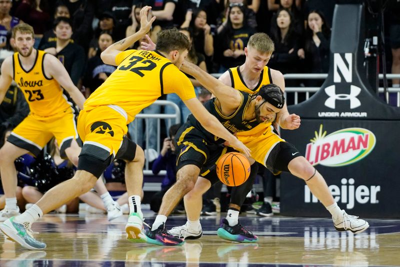 Mar 2, 2024; Evanston, Illinois, USA; Iowa Hawkeyes forward Owen Freeman (32) and Northwestern Wildcats guard Boo Buie (0) go for the ball during the first half at Welsh-Ryan Arena. Mandatory Credit: David Banks-USA TODAY Sports