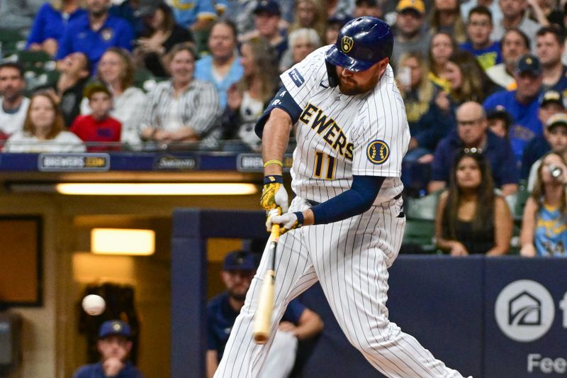 Sep 16, 2023; Milwaukee, Wisconsin, USA; Milwaukee Brewers designated hitter Rowdy Tellez (11) drives in a run with a base hit against the Washington Nationals in the first inning at American Family Field. Mandatory Credit: Benny Sieu-USA TODAY Sports