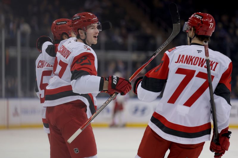 Feb 5, 2026; New York, New York, USA; Carolina Hurricanes right wing Andrei Svechnikov (37) celebrates his goal against the New York Rangers with defenseman Jalen Chatfield (5) and left wing Mark Jankowski (77) during the first period at Madison Square Garden. Mandatory Credit: Brad Penner-Imagn Images