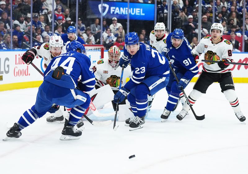 Dec 16, 2025; Toronto, Ontario, CAN; Toronto Maple Leafs left wing Matthew Knies (23) battles for the puck in front of Chicago Blackhawks goaltender Spencer Knight (30) during the first period at Scotiabank Arena. Mandatory Credit: Nick Turchiaro-Imagn Images