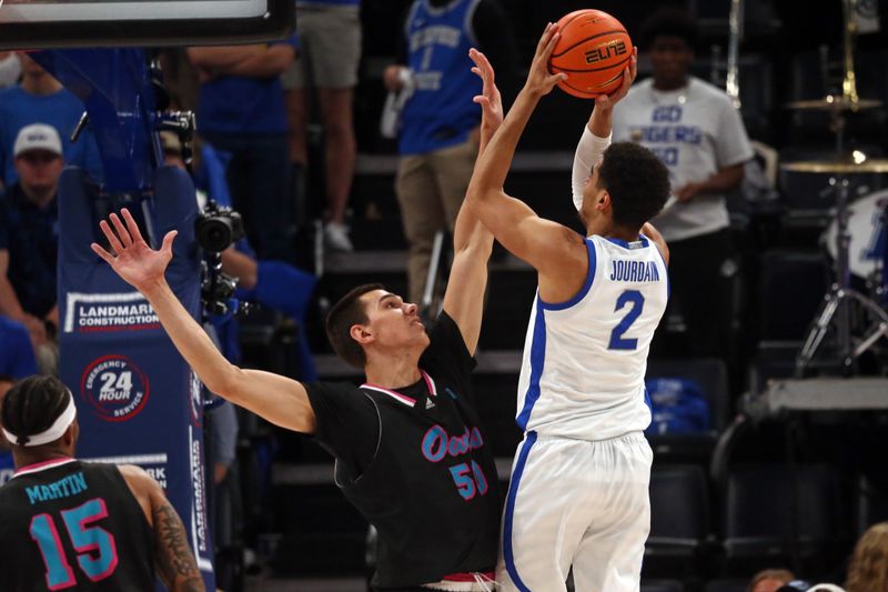 Feb 25, 2024; Memphis, Tennessee, USA; Florida Atlantic Owls center Vladislav Goldin (50) defends as Memphis Tigers forward Nicholas Jourdain (2) shoots during the second half at FedExForum. Mandatory Credit: Petre Thomas-USA TODAY Sports