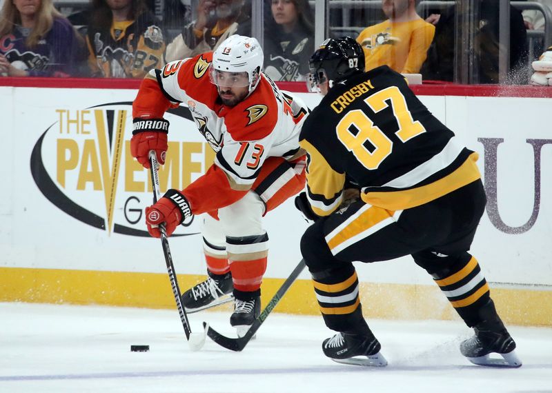 Oct 31, 2024; Pittsburgh, Pennsylvania, USA;  Anaheim Ducks center Robby Fabbri (13) moves he puck against Pittsburgh Penguins center Sidney Crosby (87) during the first period at PPG Paints Arena. Mandatory Credit: Charles LeClaire-Imagn Images