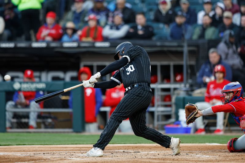 Apr 18, 2023; Chicago, Illinois, USA; Chicago White Sox first baseman Jake Burger (30) hits a three-run home run against the Philadelphia Phillies during the first inning of game two of the doubleheader at Guaranteed Rate Field. Mandatory Credit: Kamil Krzaczynski-USA TODAY Sports