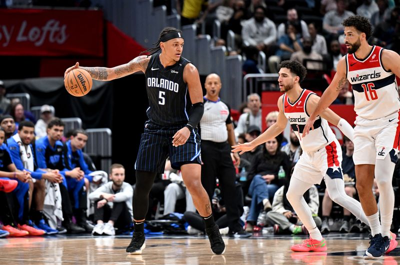 WASHINGTON, DC - APRIL 03: Paolo Banchero #5 of the Orlando Magic handles the ball in the second quarter against Colby Jones #1 of the Washington Wizards at Capital One Arena on April 03, 2025 in Washington, DC.  NOTE TO USER: User expressly acknowledges and agrees that, by downloading and or using this photograph, User is consenting to the terms and conditions of the Getty Images License Agreement.  (Photo by G Fiume/Getty Images)