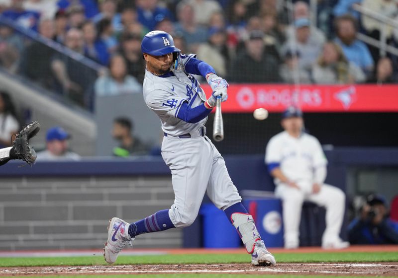 Apr 26, 2024; Toronto, Ontario, CAN; Los Angeles Dodgers first base Freddie Freeman (5) hits a single against Toronto Blue Jays during the third inning at Rogers Centre. Mandatory Credit: Nick Turchiaro-USA TODAY Sports