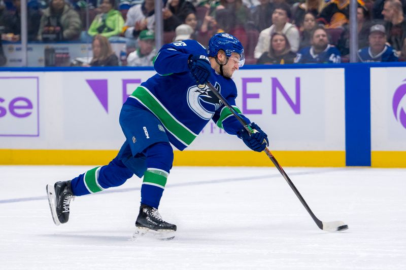 Nov 17, 2024; Vancouver, British Columbia, CAN; Vancouver Canucks defenseman Erik Brannstrom (26) scores on the shot against the Nashville Predators during the first period at Rogers Arena. Mandatory Credit: Bob Frid-Imagn Images