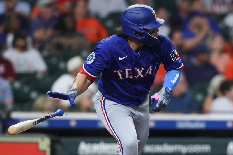 Sep 16, 2025; Houston, Texas, USA; Texas Rangers right fielder Alejandro Osuna (19) hits a double during the second inning against the Houston Astros at Daikin Park. Mandatory Credit: Troy Taormina-Imagn Images