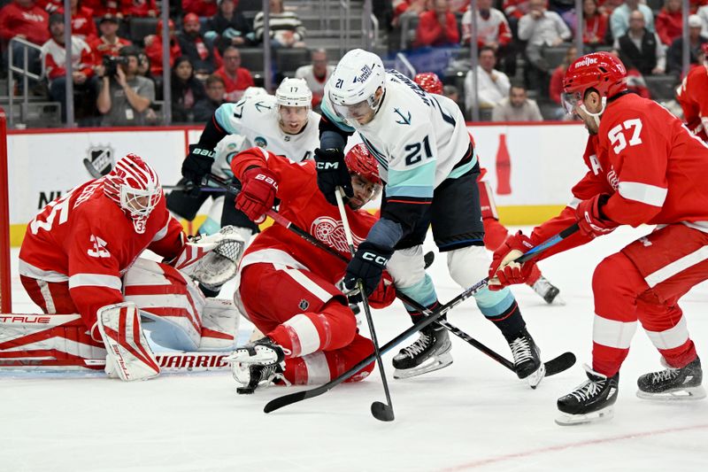 Oct 24, 2023; Detroit, Michigan, USA; Seattle Kraken center Alex Wennberg (21) tries to maneuver past Detroit Red Wings defenseman Shayne Gostisbehere (41) and left wing David Perron (57) to get off a shot on goal in the third period at Little Caesars Arena. Mandatory Credit: Lon Horwedel-USA TODAY Sports