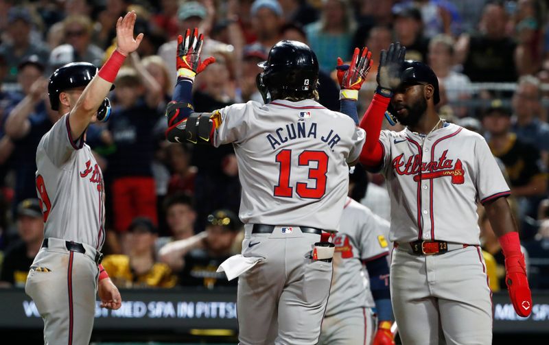 May 24, 2024; Pittsburgh, Pennsylvania, USA;  Atlanta Braves third baseman Zack Short (left) and Atlanta center fielder Michael Harris II (right) congratulate right fielder  Ronald Acuna Jr. (13) crossing home plate on a three-run home run against the Pittsburgh Pirates during the eighth inning at PNC Park. Mandatory Credit: Charles LeClaire-USA TODAY Sports