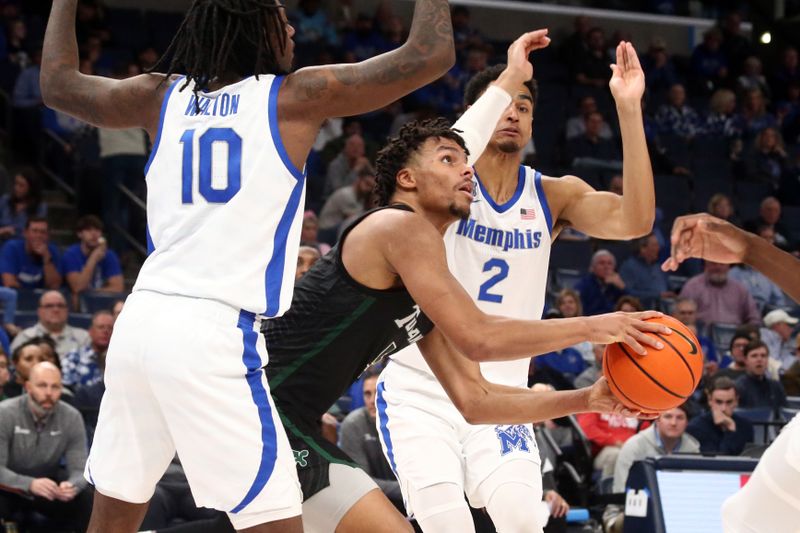 Feb 11, 2024; Memphis, Tennessee, USA; Tulane Green Wave forward Collin Holloway (5) drives to the basket between Memphis Tigers guard Jaykwon Walton (10) and forward Nicholas Jourdain (2) during the second half at FedExForum. Mandatory Credit: Petre Thomas-USA TODAY Sports