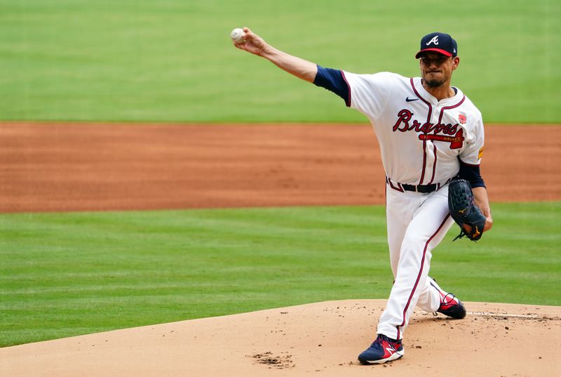 May 27, 2024; Cumberland, Georgia, USA; Atlanta Braves pitcher Charlie Morton (50) fires off a pitch against the Washington Nationals during the first inning at Truist Park. Mandatory Credit: John David Mercer-USA TODAY Sports