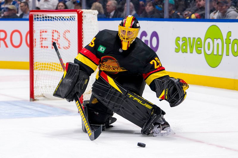 Mar 19, 2024; Vancouver, British Columbia, CAN; Vancouver Canucks goalie Casey DeSmith (29) handles the puck against the Buffalo Sabres in the second period at Rogers Arena. Mandatory Credit: Bob Frid-USA TODAY Sports