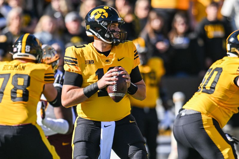 Oct 21, 2023; Iowa City, Iowa, USA; Iowa Hawkeyes quarterback Deacon Hill (10) looks to throw a pass against the Minnesota Golden Gophers during the first quarter at Kinnick Stadium. Mandatory Credit: Jeffrey Becker-USA TODAY Sports