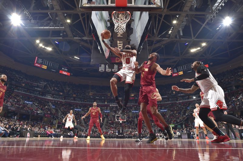 CLEVELAND, OH - FEBRUARY 14: Coby White #0 of the Chicago Bulls shoots the ball during the game against the Cleveland Cavaliers on February 14, 2024 at Rocket Mortgage FieldHouse in Cleveland, Ohio. NOTE TO USER: User expressly acknowledges and agrees that, by downloading and/or using this Photograph, user is consenting to the terms and conditions of the Getty Images License Agreement. Mandatory Copyright Notice: Copyright 2024 NBAE (Photo by David Liam Kyle/NBAE via Getty Images)