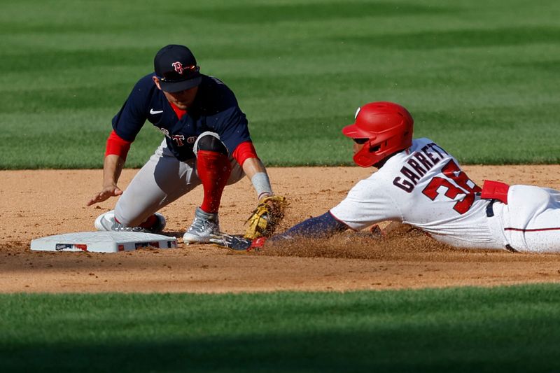 Aug 17, 2023; Washington, District of Columbia, USA; Washington Nationals left fielder Stone Garrett (36) slide into second base with an RBI double ahead of a tag by Boston Red Sox shortstop Trevor Story (10) during the fifth inning at Nationals Park. Mandatory Credit: Geoff Burke-USA TODAY Sports