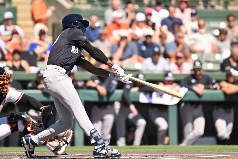 Feb 20, 2026; Sarasota, Florida, USA; New York Yankees second baseman Jazz Chisholm Jr. (13) hits a single in the first inning against the Baltimore Orioles during spring training at Ed Smith Stadium. Mandatory Credit: Jonathan Dyer-Imagn Images