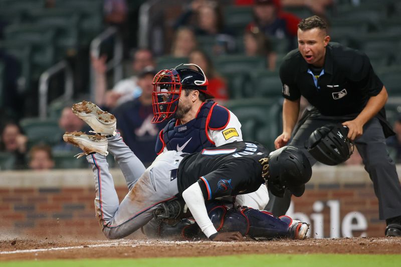 Apr 24, 2024; Atlanta, Georgia, USA; Atlanta Braves catcher Travis d'Arnaud (16) tags out Miami Marlins left fielder Nick Gordon (1) in the tenth inning at Truist Park. Mandatory Credit: Brett Davis-USA TODAY Sports