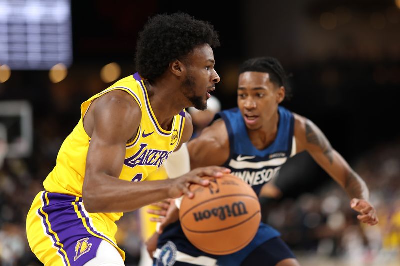 PALM SPRINGS, CALIFORNIA - OCTOBER 04: Bronny James #9 of the Los Angeles Lakers dribbles past the defense of Rob Dillingham #4 of the Minnesota Timberwolves during the first half of a game at Acrisure Arena on October 04, 2024 in Palm Springs, California.  (Photo by Sean M. Haffey/Getty Images)