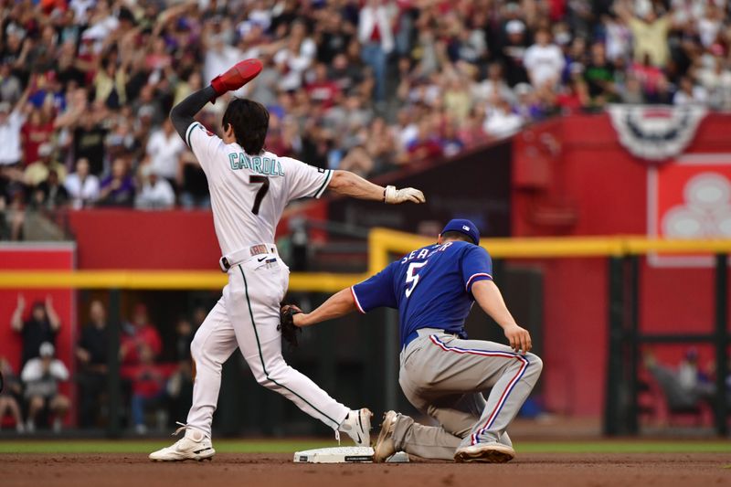 Nov 1, 2023; Phoenix, AZ, USA;  Arizona Diamondbacks left fielder Corbin Carroll (7) steals second base infant of Texas Rangers shortstop Corey Seager (5) in the first inning in game five of the 2023 World Series at Chase Field. Mandatory Credit: Matt Kartozian-USA TODAY Sports