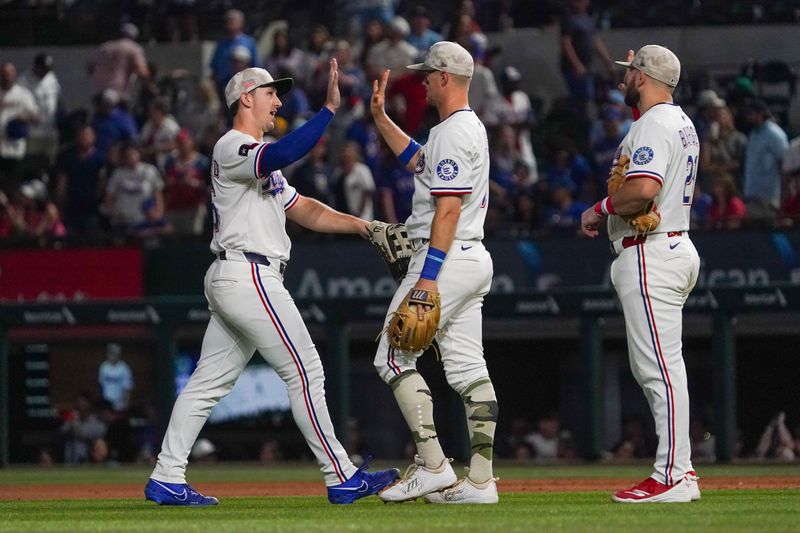 May 17, 2025; Arlington, Texas, USA; Texas Rangers outfielder Wyatt Langford (36) high fives third baseman Josh Jung (6) following a game against the Houston Astros at Globe Life Field. Mandatory Credit: Raymond Carlin III-Imagn Images