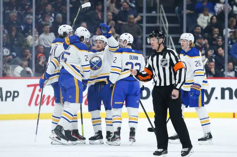 Jan 26, 2023; Winnipeg, Manitoba, CAN;  Buffalo Sabres forward Owen Power (25) is congratulated by his team mates on his goal against the Winnipeg Jets during the second period at Canada Life Centre. Mandatory Credit: Terrence Lee-USA TODAY Sports