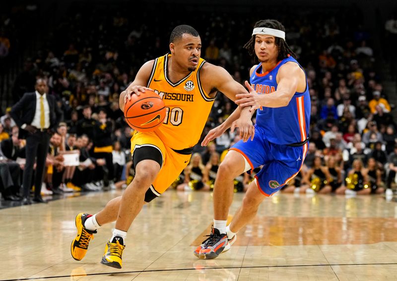 Jan 20, 2024; Columbia, Missouri, USA; Missouri Tigers guard Nick Honor (10) drives against Florida Gators guard Walter Clayton Jr. (1) during the first half at Mizzou Arena. Mandatory Credit: Jay Biggerstaff-USA TODAY Sports