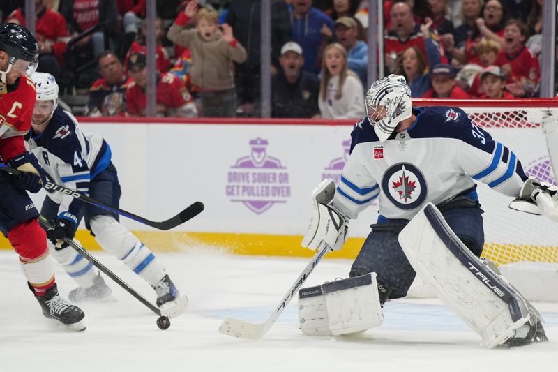 Nov 16, 2024; Sunrise, Florida, USA;  Florida Panthers center Aleksander Barkov (16) shoots and scores a short-handed goal against Winnipeg Jets goaltender Connor Hellebuyck (37) during the second period at Amerant Bank Arena. Mandatory Credit: Jim Rassol-Imagn Images