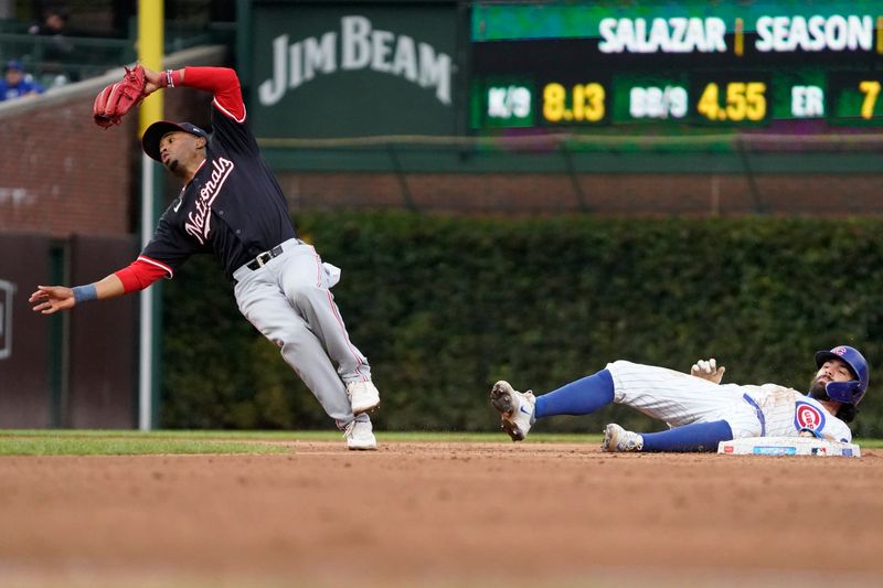 Sep 22, 2024; Chicago, Illinois, USA; Chicago Cubs shortstop Dansby Swanson (7) is picked-off of second base as Washington Nationals shortstop Nasim Nuñez (26) takes the throw during the seventh inning at Wrigley Field. Mandatory Credit: David Banks-Imagn Images