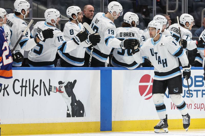 Jan 1, 2026; Elmont, New York, USA;  Utah Mammoth right wing Dylan Guenther (11) celebrates with his teammates after scoring a goal in the second period against the New York Islanders at UBS Arena. Mandatory Credit: Wendell Cruz-Imagn Images