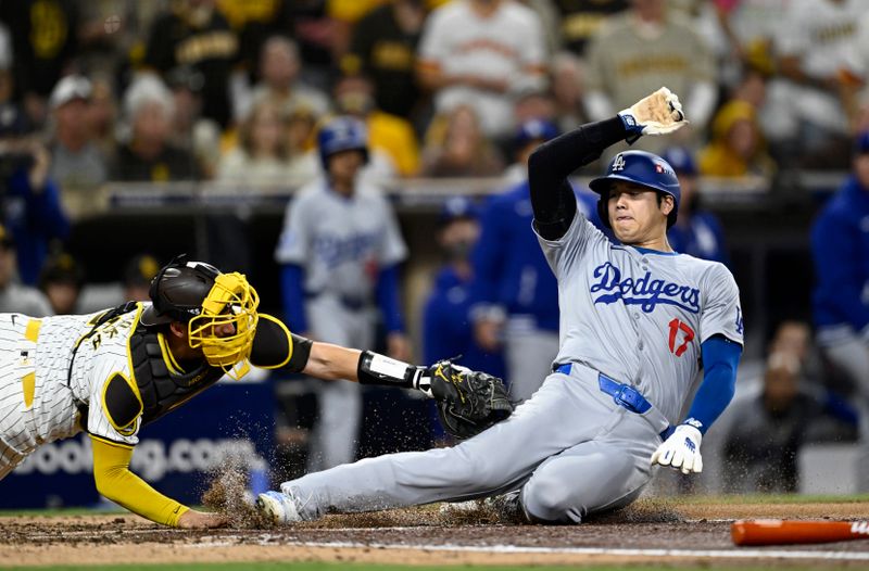 Oct 9, 2024; San Diego, California, USA; San Diego Padres catcher Kyle Higashioka (20) tags out Los Angeles Dodgers designated hitter Shohei Ohtani (17) at home in the fourth inning during game four of the NLDS for the 2024 MLB Playoffs at Petco Park.  Mandatory Credit: Denis Poroy-Imagn Images