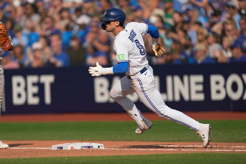 Sep 17, 2023; Toronto, Ontario, CAN; Toronto Blue Jays right fielder Cavan Biggio (8) runs to first base on a single against the Boston Red Sox during the ninth inning at Rogers Centre. Mandatory Credit: John E. Sokolowski-USA TODAY Sports