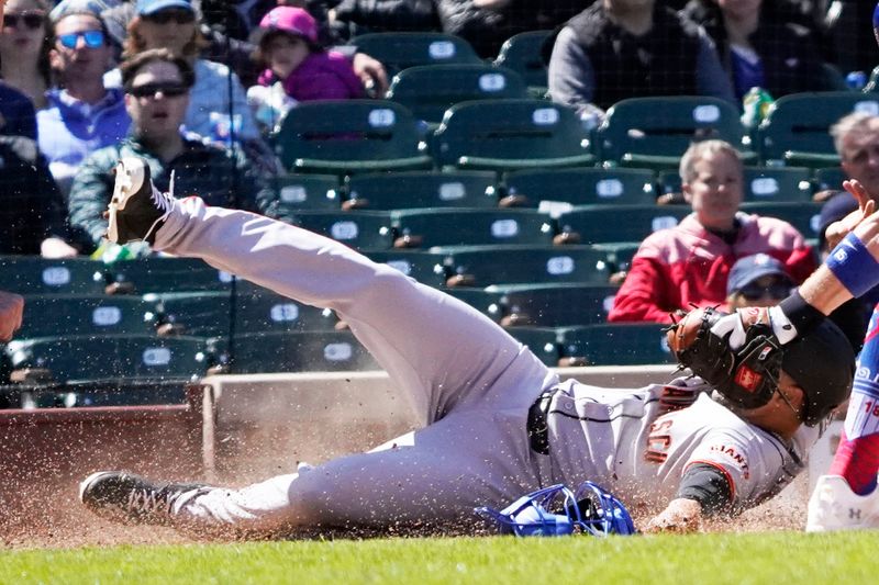May 7, 2025; Chicago, Illinois, USA; San Francisco Giants first base LaMonte Wade Jr. (31) is tagged out at home plate by Chicago Cubs catcher Carson Kelly (15) during the fourth inning at Wrigley Field. Mandatory Credit: David Banks-Imagn Images