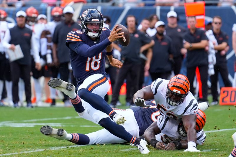 Chicago Bears quarterback Caleb Williams (18) breaks away from a tackle against the Cincinnati Bengals during the first half of an NFL preseason football game, Saturday, Aug. 17, 2024, at Soldier Field in Chicago. (AP Photo/Charles Rex Arbogast)