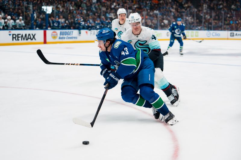 Sep 26, 2025; Vancouver, British Columbia, CAN; Vancouver Canucks defenseman Quinn Hughes (43) drives past Seattle Kraken defenseman Ville Ottavainen (46) in the third period at Rogers Arena. Mandatory Credit: Bob Frid-Imagn Images