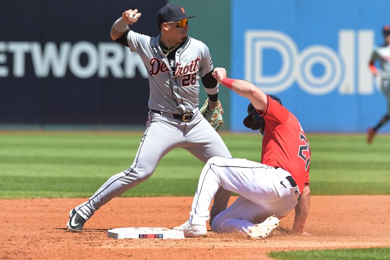 May 8, 2024; Cleveland, Ohio, USA; Detroit Tigers shortstop Javier Baez (28) forces out Cleveland Guardians catcher Austin Hedges (27) during the second inning at Progressive Field. Mandatory Credit: Ken Blaze-USA TODAY Sports