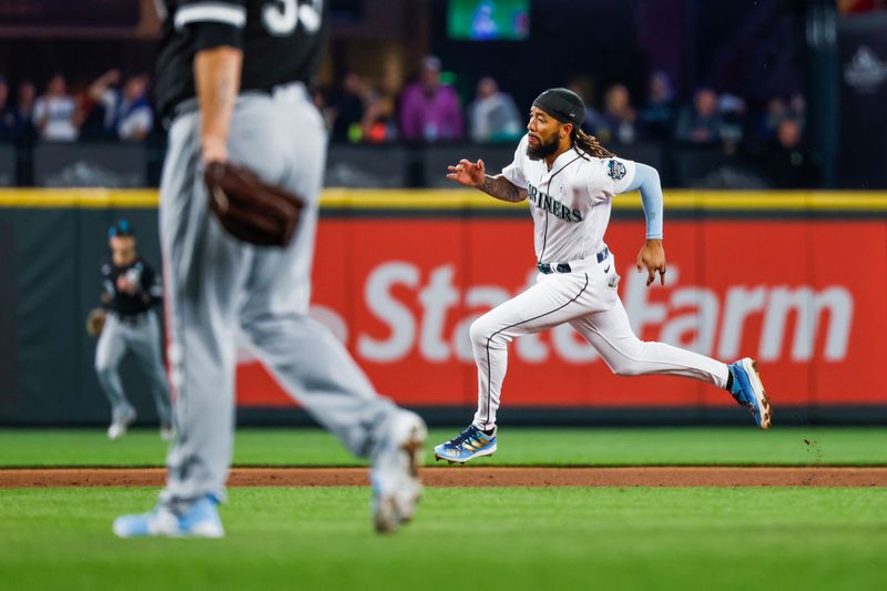 Jun 18, 2023; Seattle, Washington, USA; Seattle Mariners shortstop J.P. Crawford (3) advances from first base to score a run against the Chicago White Sox during the third inning at T-Mobile Park. Mandatory Credit: Joe Nicholson-USA TODAY Sports