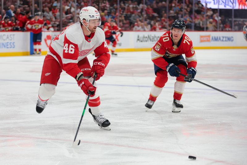 Apr 10, 2025; Sunrise, Florida, USA; Detroit Red Wings defenseman Jeff Petry (46) moves the puck ahead of Florida Panthers center Jesper Boqvist (70) during the first period at Amerant Bank Arena. Mandatory Credit: Sam Navarro-Imagn Images