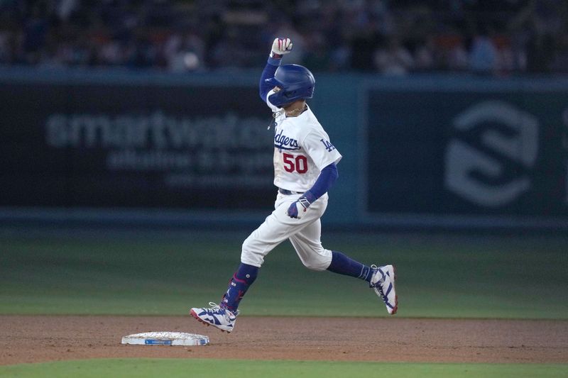 Aug 31, 2023; Los Angeles, California, USA; Los Angeles Dodgers second baseman Mookie Betts (50) runs the bases after hitting a three run home urn in the fifth inning against the Atlanta Braves at Dodger Stadium. Mandatory Credit: Kirby Lee-USA TODAY Sports