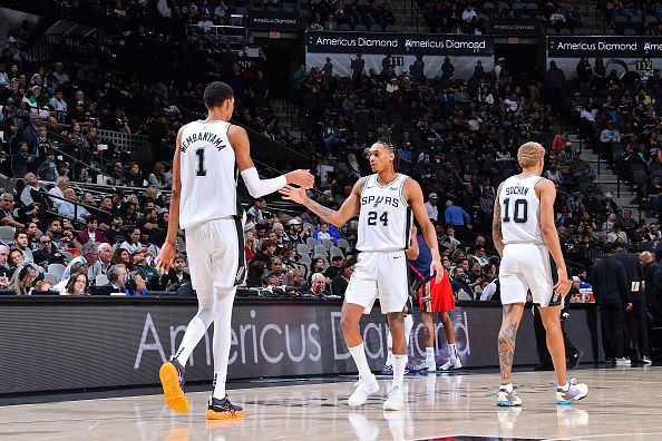 SAN ANTONIO, TX - DECEMBER 17: Victor Wembanyama #1 and Devin Vassell #24 of the San Antonio Spurs high five during the game against the New Orleans Pelicans on December 17, 2023 at the Frost Bank Center in San Antonio, Texas. NOTE TO USER: User expressly acknowledges and agrees that, by downloading and or using this photograph, user is consenting to the terms and conditions of the Getty Images License Agreement. Mandatory Copyright Notice: Copyright 2023 NBAE (Photos by Michael Gonzales/NBAE via Getty Images)