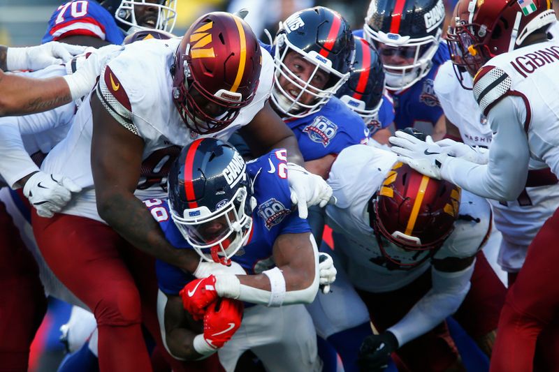 New York Giants running back Tyrone Tracy Jr. (29) is tackled by the Washington Commanders during the third quarter of an NFL football game, Sunday, Nov. 3, 2024, in East Rutherford, N.J. (AP Photo/John Munson)