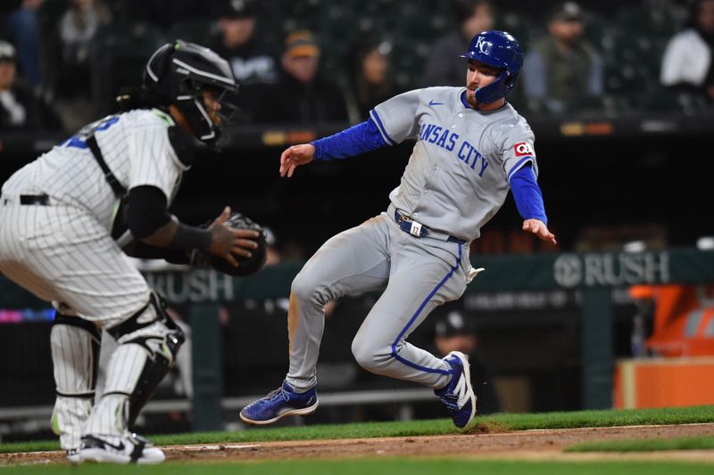 Apr 15, 2024; Chicago, Illinois, USA; Kansas City Royals designated hitter Nick Loftin (12) slides in to score during the fifth inning against the Chicago White Sox at Guaranteed Rate Field. Mandatory Credit: Patrick Gorski-USA TODAY Sports