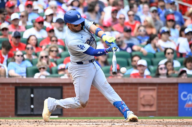 Aug 18, 2024; St. Louis, Missouri, USA; Los Angeles Dodgers third baseman Miguel Rojas (11) hits an RBI single against the St. Louis Cardinals in the fifth inning at Busch Stadium. Mandatory Credit: Joe Puetz-USA TODAY Sports