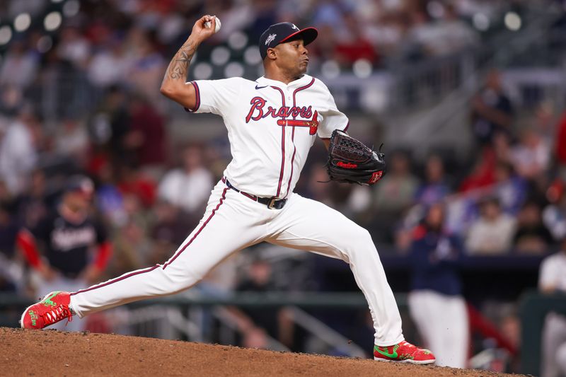 May 12, 2025; Atlanta, Georgia, USA; Atlanta Braves relief pitcher Raisel Iglesias (26) throws against the Washington Nationals in the ninth inning at Truist Park. Mandatory Credit: Brett Davis-Imagn Images