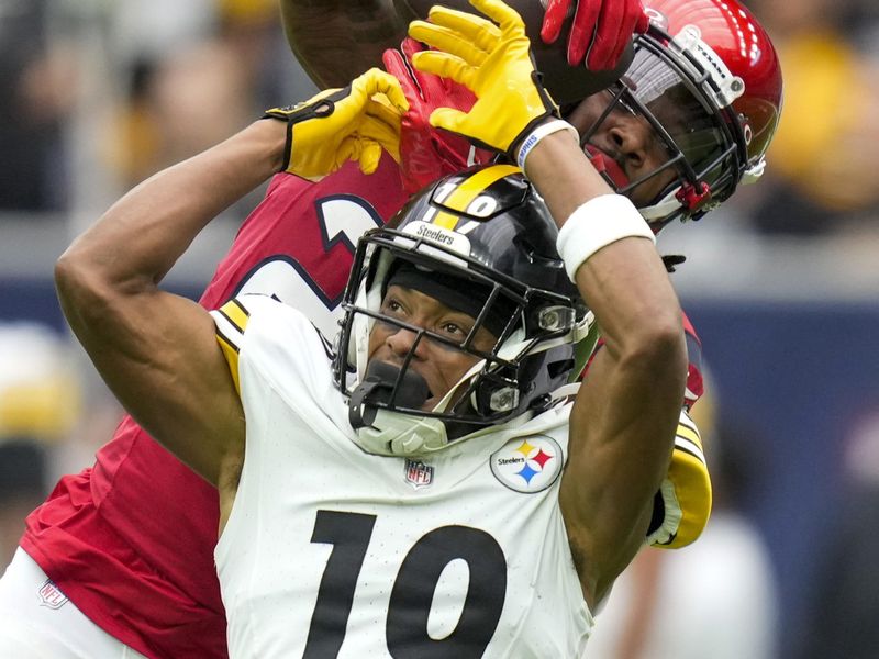 Houston Texans cornerback Steven Nelson, rear, intercepts a pass intended for Pittsburgh Steelers wide receiver Calvin Austin III (19) during the first half of an NFL football game, Sunday, Oct. 1, 2023, in Houston. (AP Photo/Eric Christian Smith)